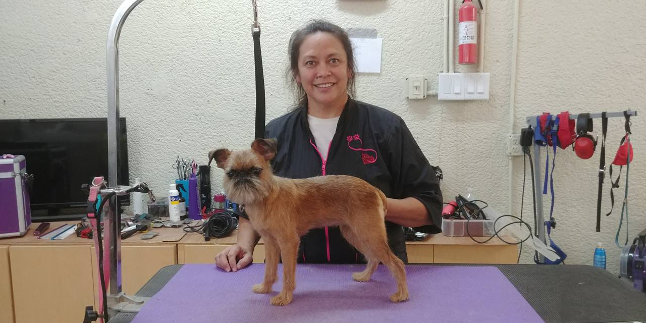 Yvette with a happy groomed dog at Sarasota Grooming Company